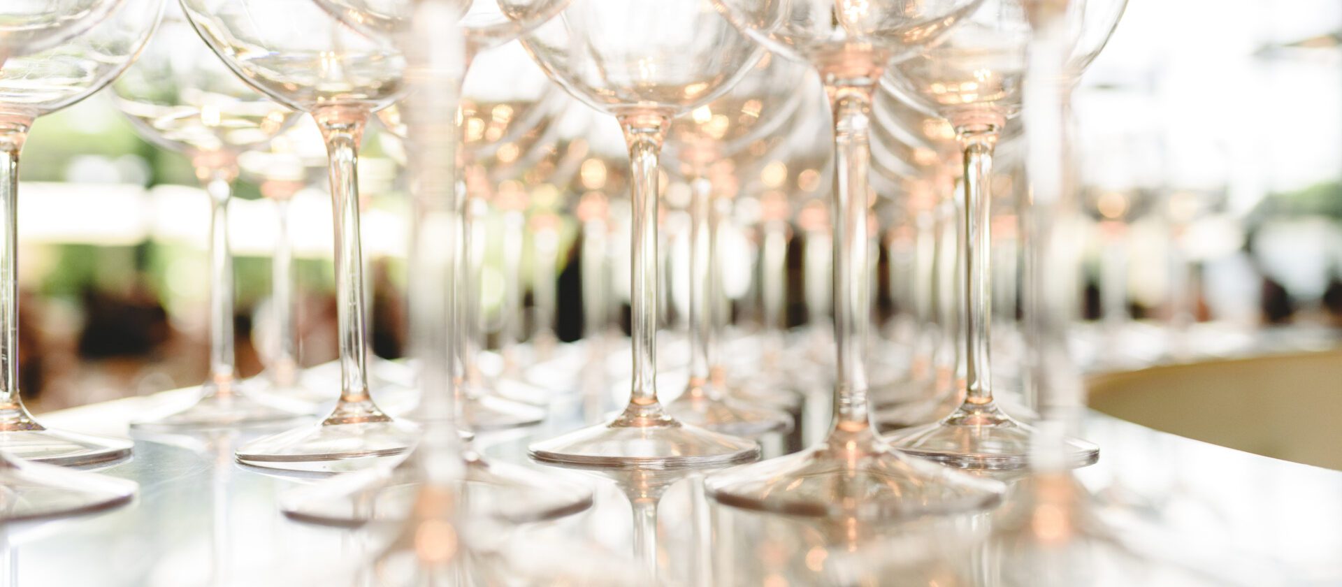 Group of empty transparent glasses ready for a party in a bar.